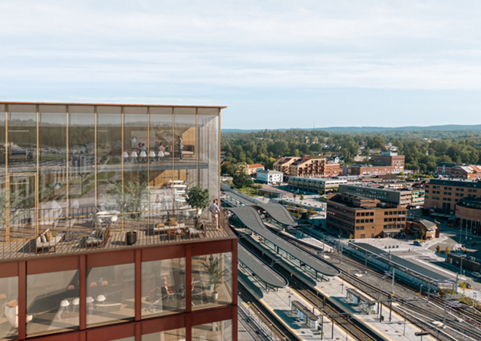 Moderne kontorbygg sett ovenfra. Togstasjon i bakgrunnen.