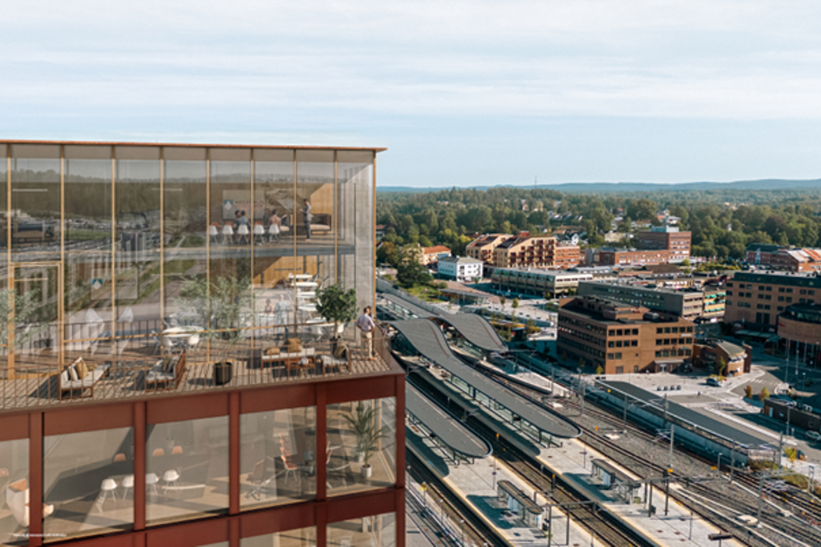 Toppen av fylkeshuset i forgrunn med Ski stasjon i bakgrunnen